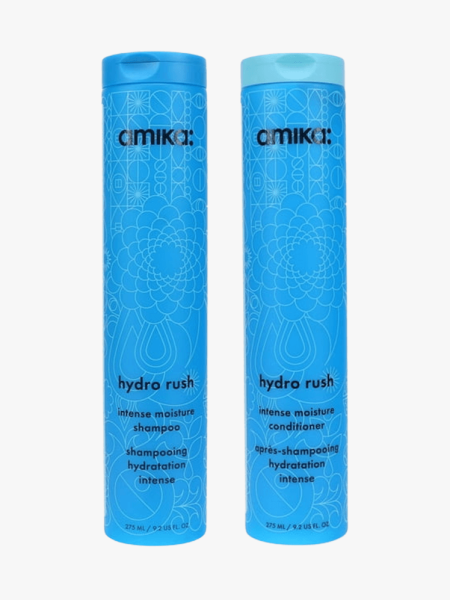 Amika Hydro Rush Intense Moisture Shampoo and Conditioner on a grey background